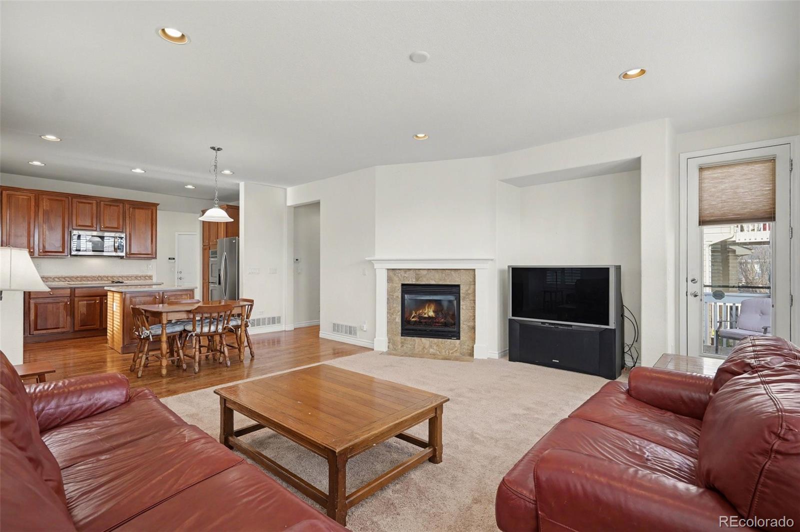 10844 Huntwick Street Highlands Ranch, CO 80130 - Photo 9 of 29 a living room with furniture and a fireplace