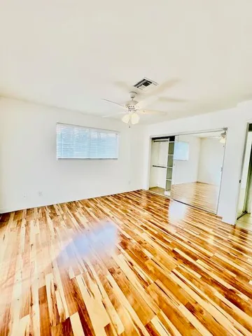 a view of a room with wooden floor
