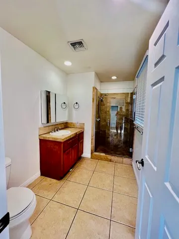 a spacious bathroom with a sink and a mirror