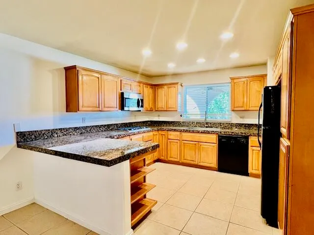 a kitchen with a stove a sink and a refrigerator