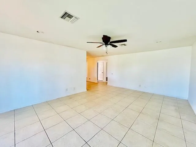 a view of a room with a ceiling fan