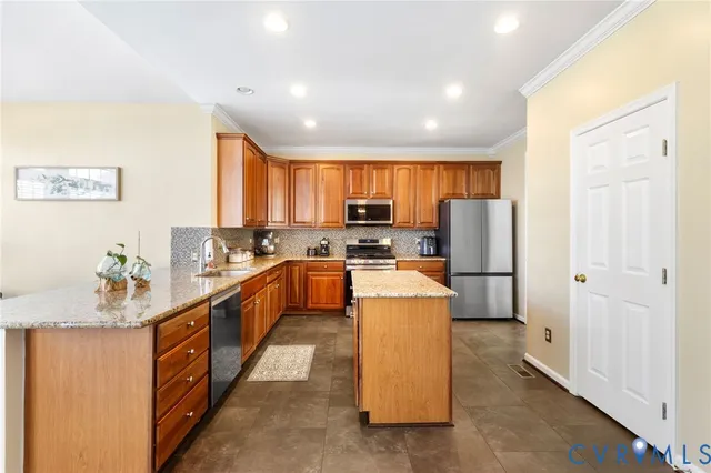 a kitchen with refrigerator a stove a sink dishwasher and wooden cabinets with wooden floor