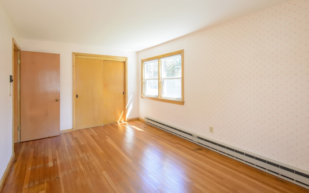 11 Dartmouth Road Marblehead, MA 01945 - Photo 18 of 25 an empty room with wooden floor and windows