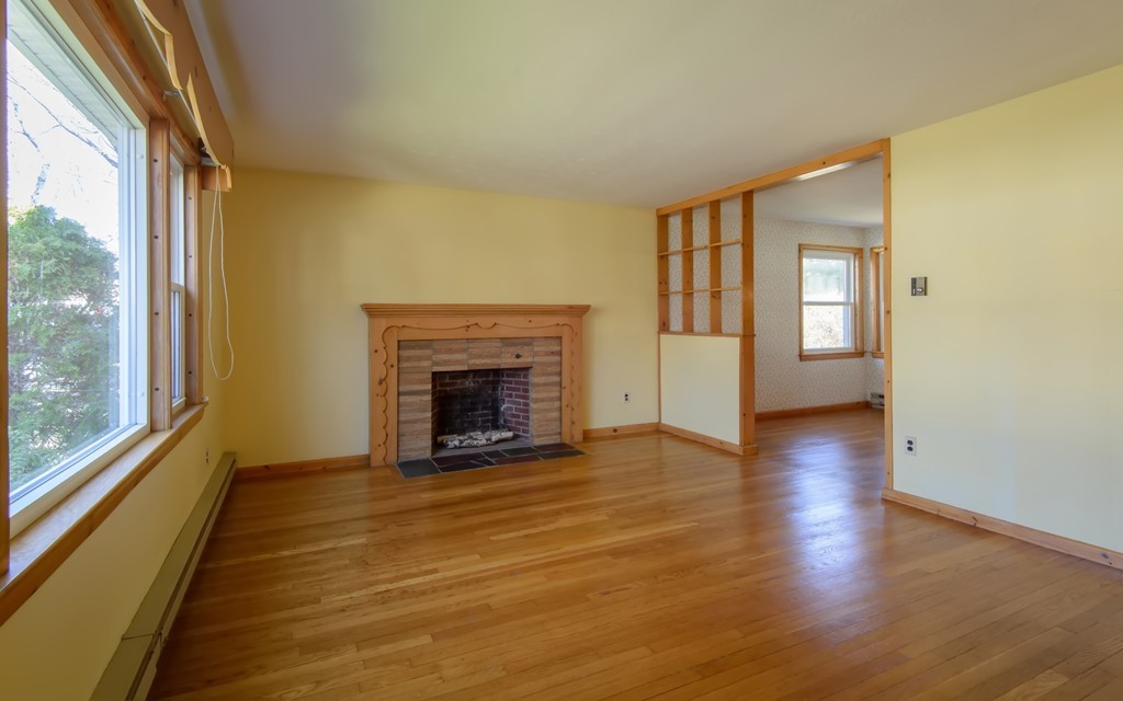 11 Dartmouth Road Marblehead, MA 01945 - Photo 4 of 25 a view of an empty room with window and fire place