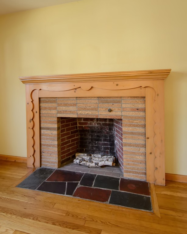 11 Dartmouth Road Marblehead, MA 01945 - Photo 7 of 25 a room with a fireplace and wooden floor