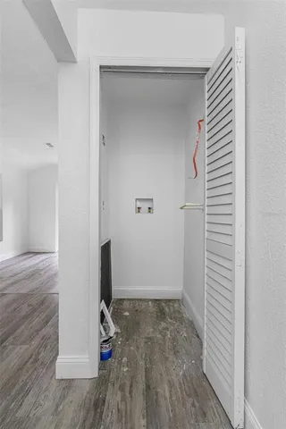 an entryway of a room with wooden floor