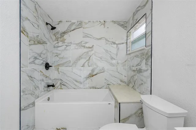 a bathroom with a toilet sink and bathtub