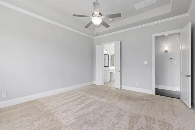 a view of a room with a ceiling fan and bathroom