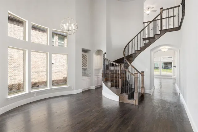 a view of entryway with wooden floor and stairs
