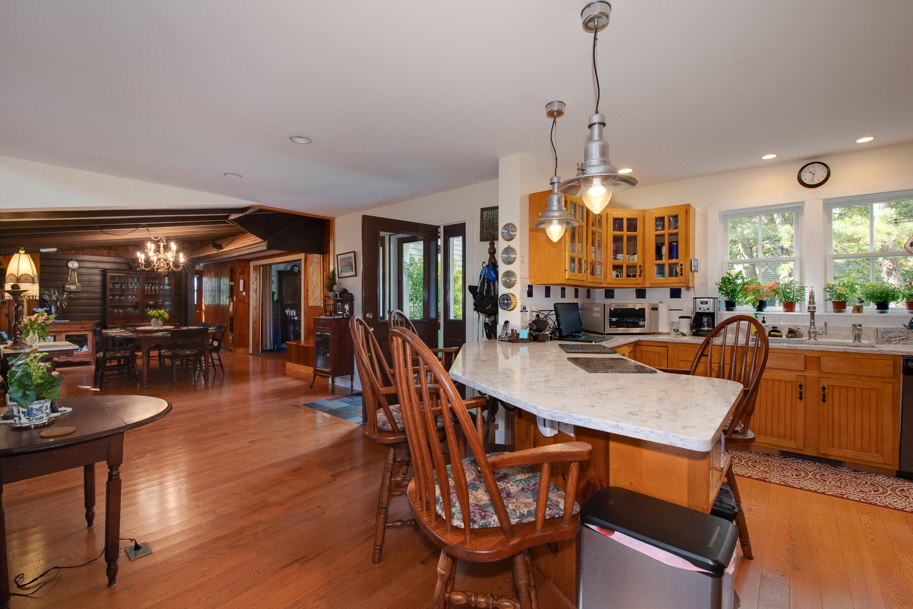 23 Forest Beach Rd Extension South Chatham, MA 02659 - Photo 23 of 43 a dining room with wooden floor a chandelier a wooden table and chairs