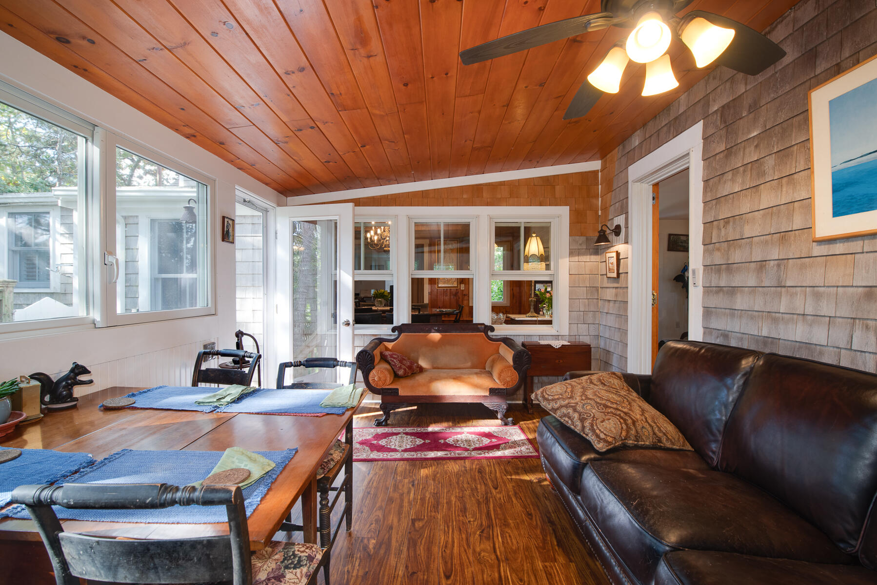 23 Forest Beach Rd Extension South Chatham, MA 02659 - Photo 29 of 43 a living room with furniture a fireplace and large windows