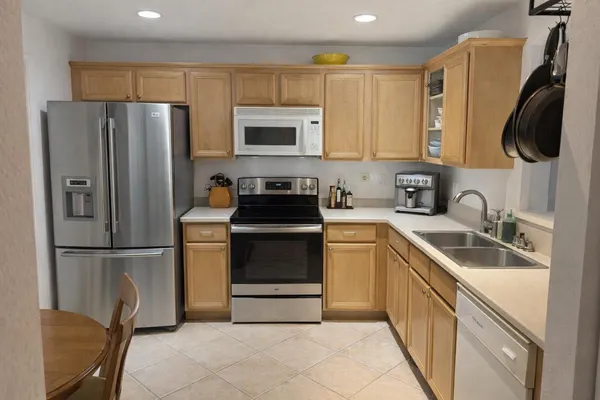 a kitchen with a refrigerator sink and microwave