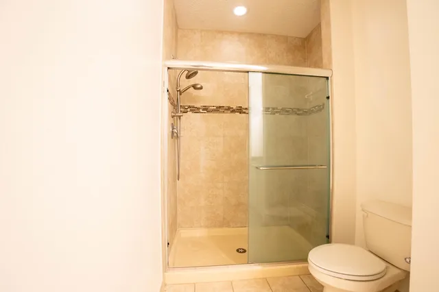 a kitchen with granite countertop a stove top oven and cabinets