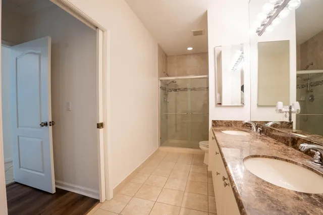 a kitchen with granite countertop a refrigerator a sink a stove a microwave and cabinets