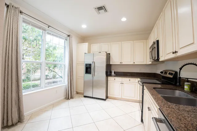 a kitchen with white cabinets and white stainless steel appliances