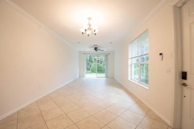 a view of a livingroom with an empty space and a window