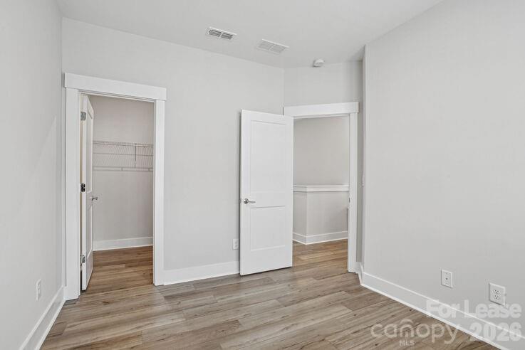 4375 Raleigh Street, Unit C1 Charlotte, NC 28213 - Photo 13 of 19 a view of an empty room with wooden floor