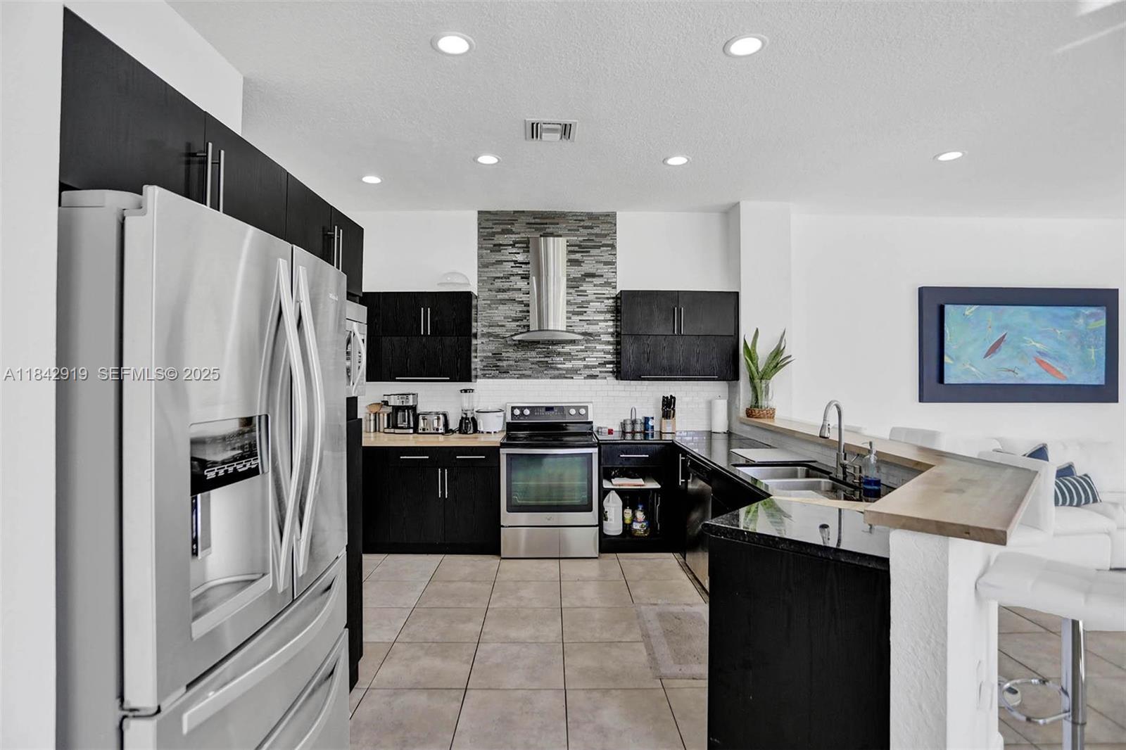 721 Ranch Road Weston, FL 33326 - Photo 36 of 38 a kitchen with stainless steel appliances a refrigerator stove and microwave