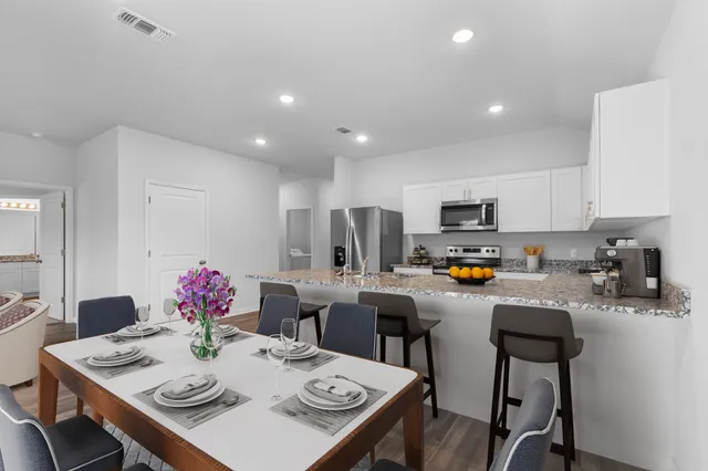 a kitchen with stainless steel appliances granite countertop a stove and a microwave