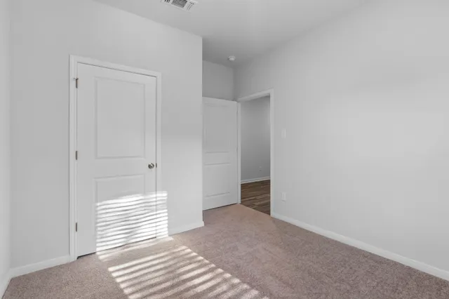 a bedroom with bed and a potted plant