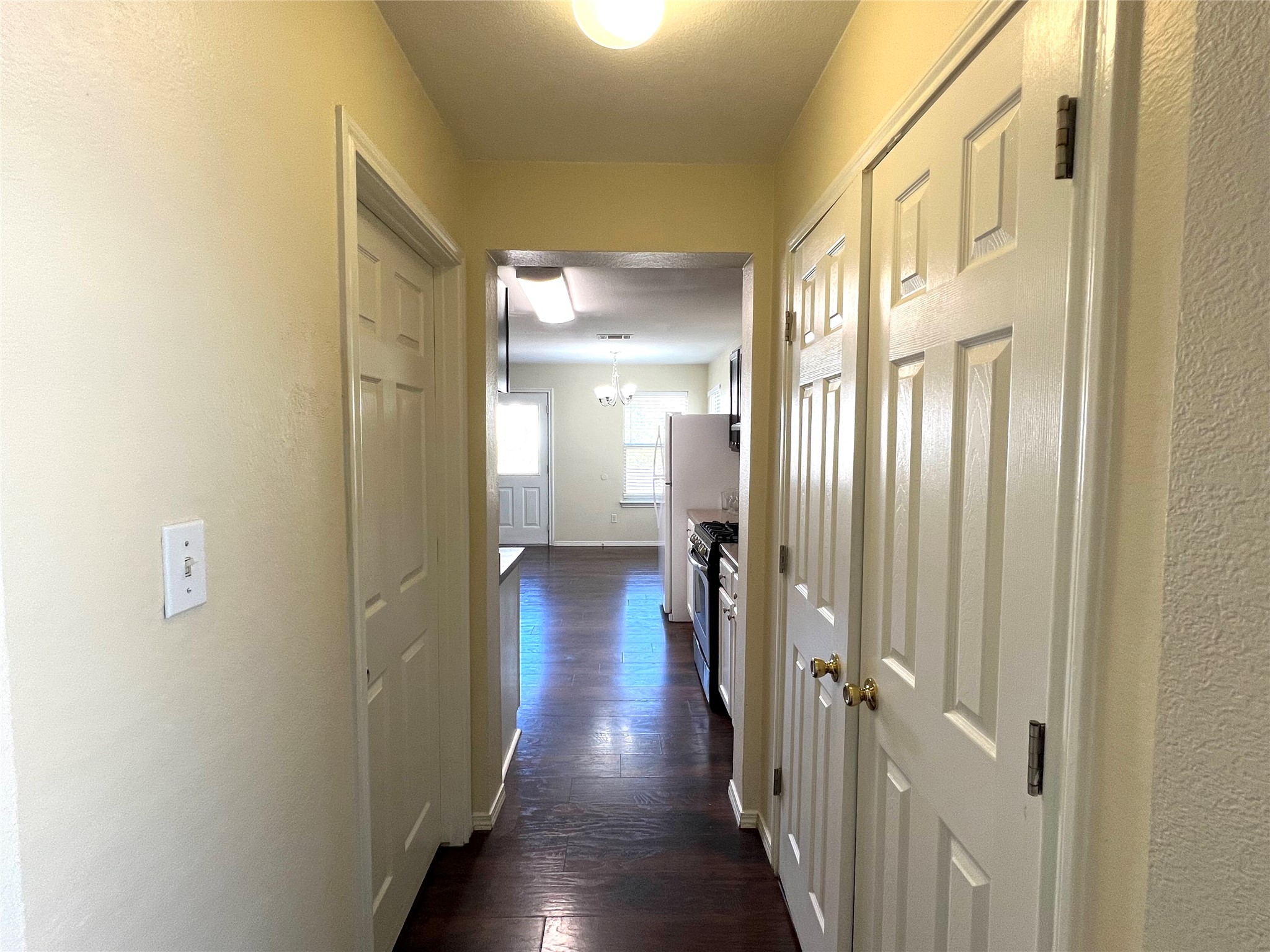125 Dandelion Loop Kyle, TX 78640 - Photo 11 of 25 a view of a hallway with wooden floor
