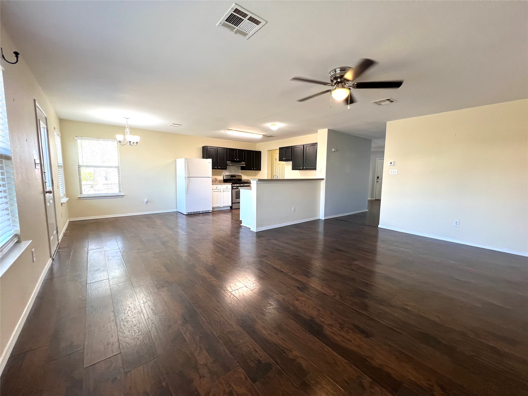 125 Dandelion Loop Kyle, TX 78640 - Photo 16 of 25 a view of a livingroom with a ceiling fan window and wooden floor