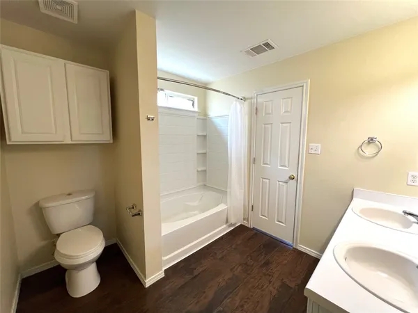 a bathroom with a toilet and a sink