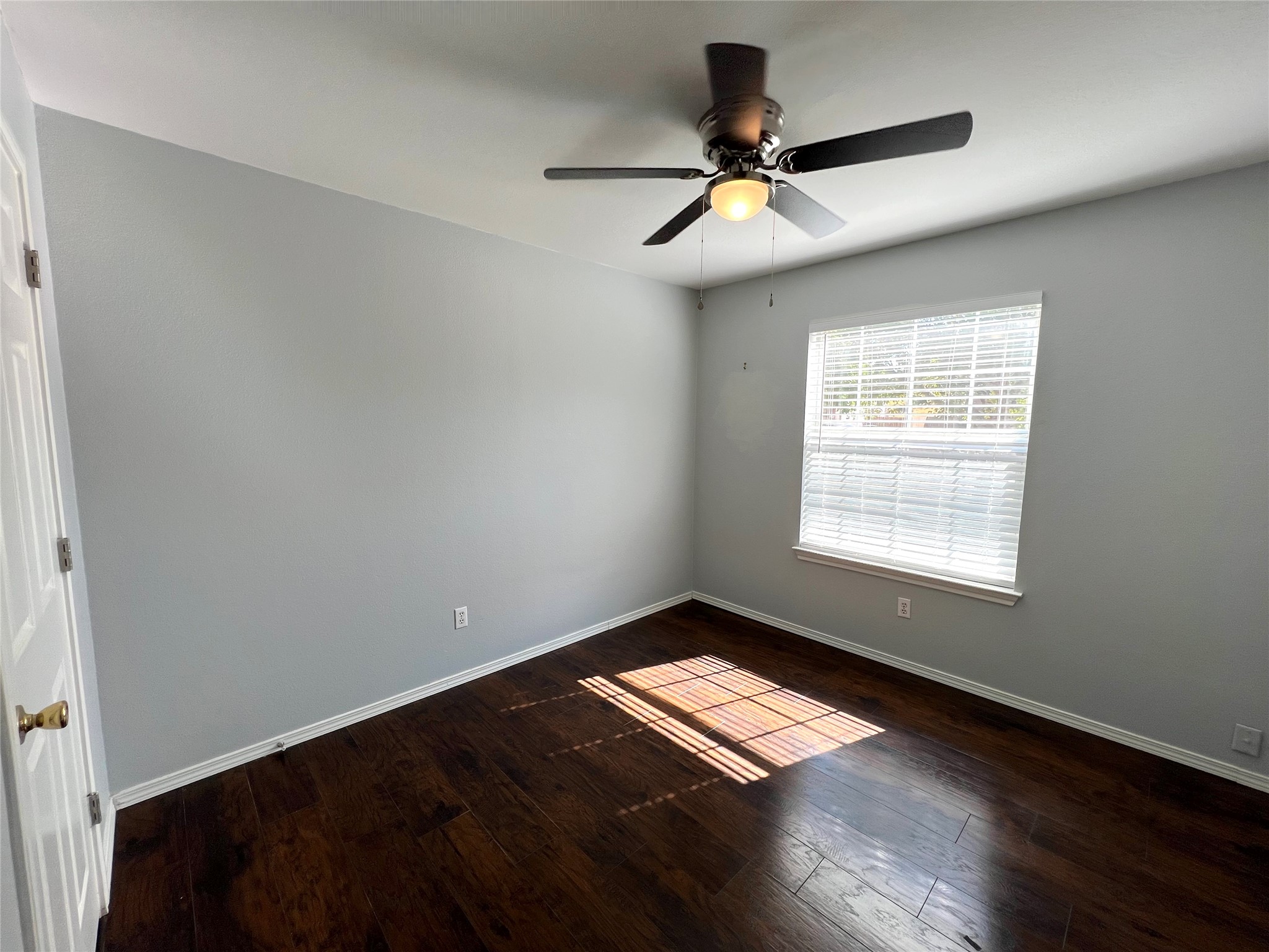 125 Dandelion Loop Kyle, TX 78640 - Photo 8 of 25 a view of empty room with wooden floor and fan