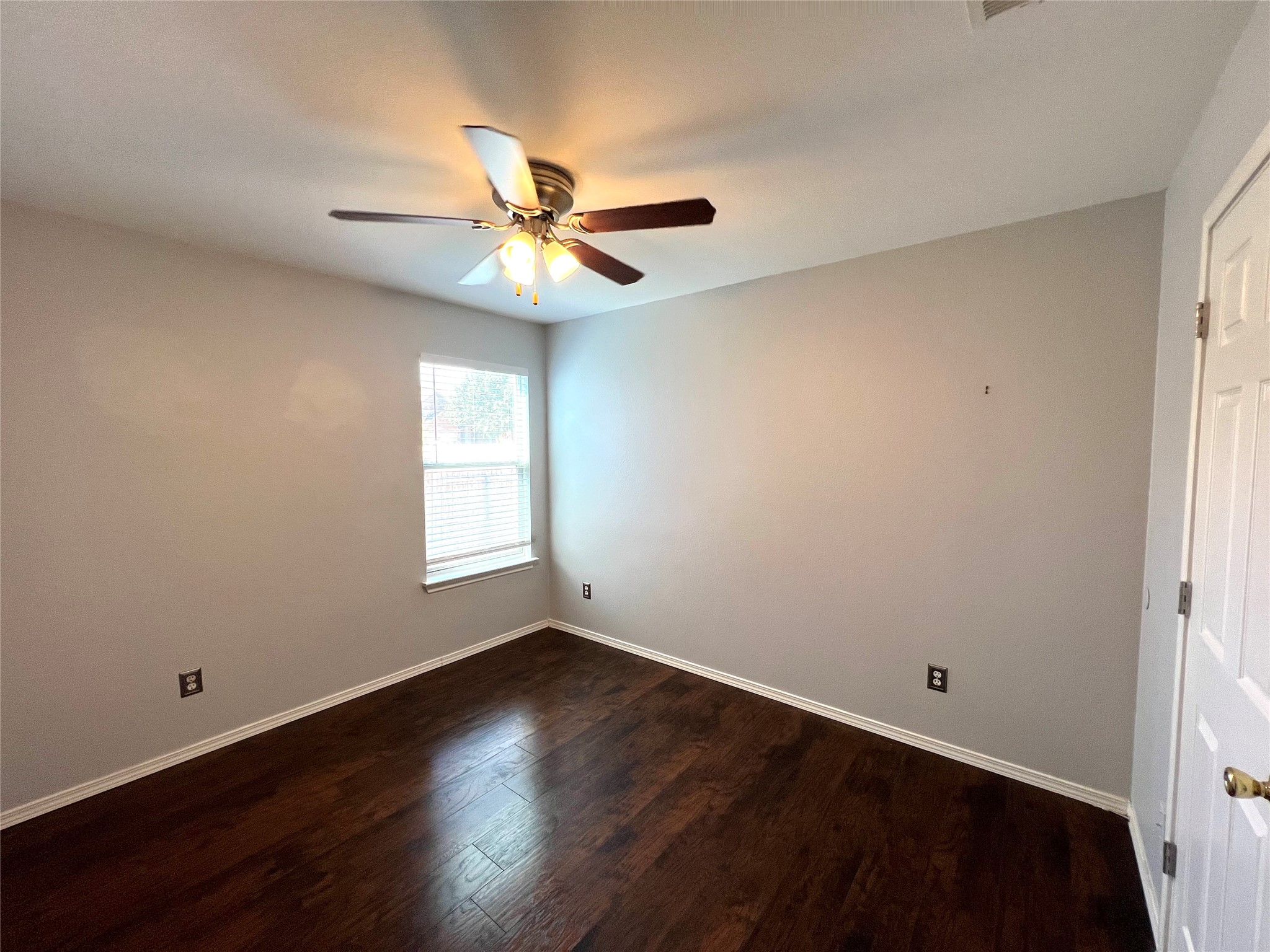125 Dandelion Loop Kyle, TX 78640 - Photo 10 of 25 a view of empty room with wooden floor and fan