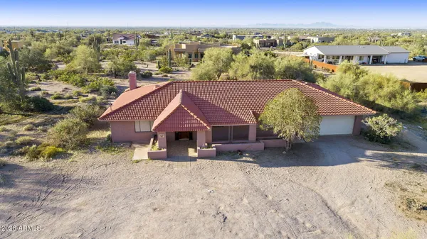 an aerial view of a house with a yard sitting space