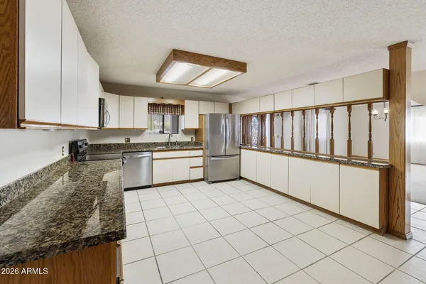 a kitchen with a sink window and cabinets