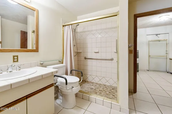 a bathroom with a sink toilet and shower