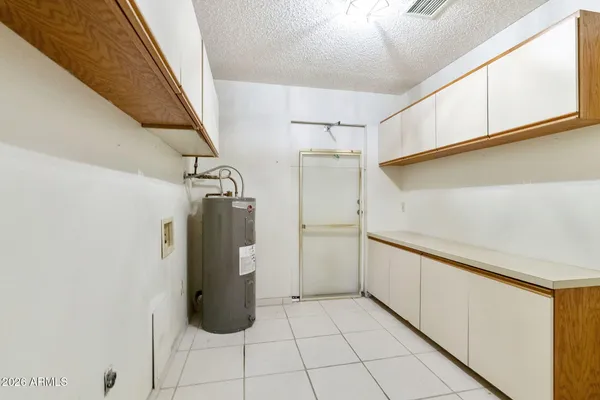 a walk in closet with wooden floor
