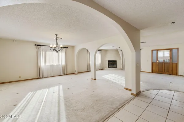 a view of a livingroom with wooden floor and staircase