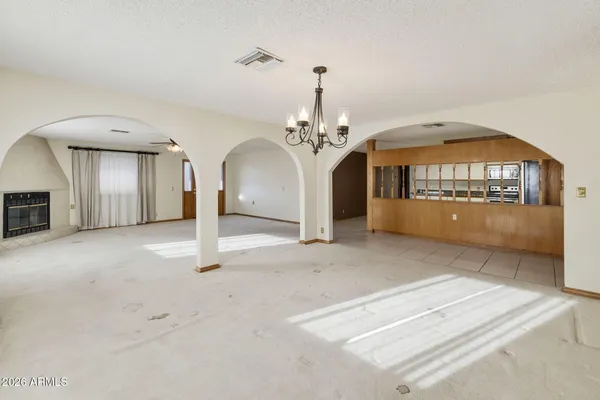a view of a big room with chandelier and couches
