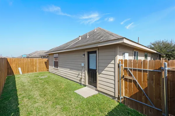 a backyard of a house with wooden fence and deck