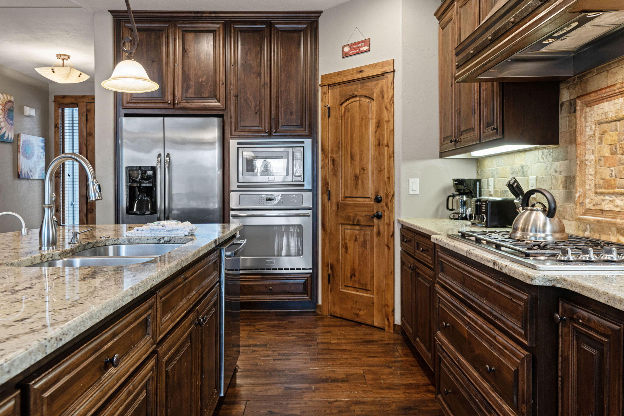 56508 Dancing Rock Loop, Unit 22 Bend, OR 97707 - Photo 19 of 69 a kitchen with stainless steel appliances granite countertop a refrigerator and a sink