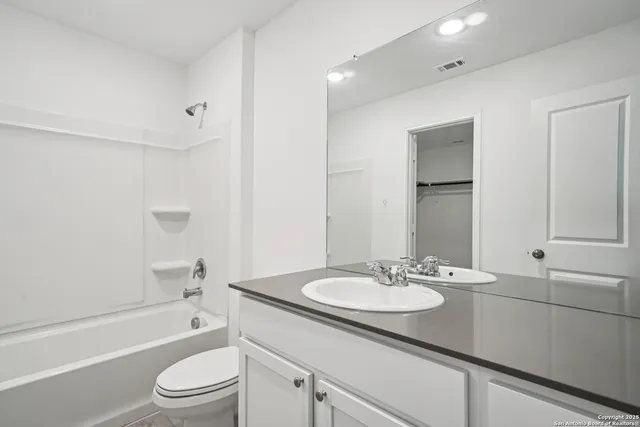 a bathroom with a sink double vanity granite toilet tub and shower