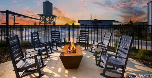 a view of a chairs and table in patio
