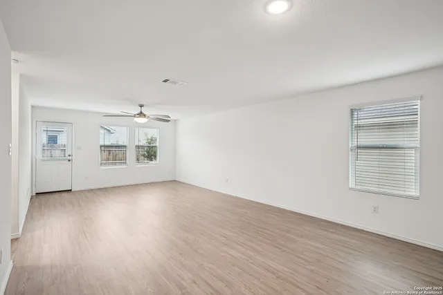 wooden floor in an empty room with a window