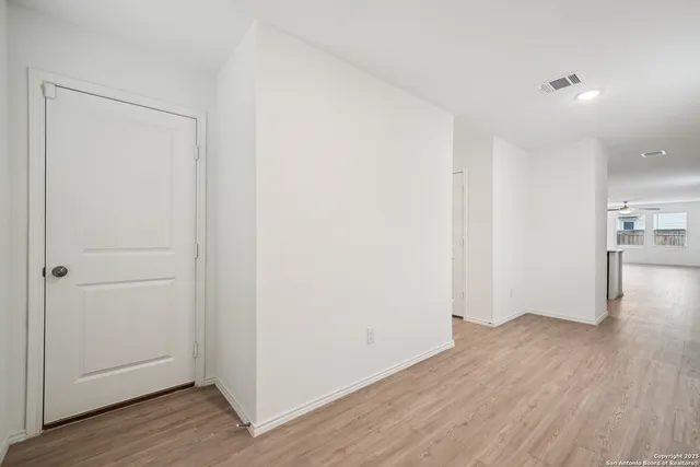 a view of a room with wooden floor