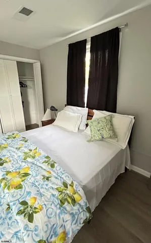 a bedroom with a bed and a mirror