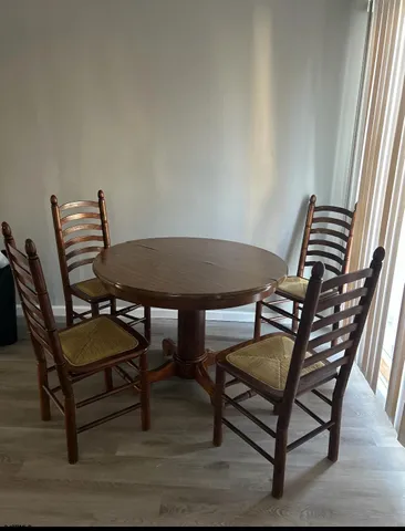 a view of a room with chairs and wooden floor