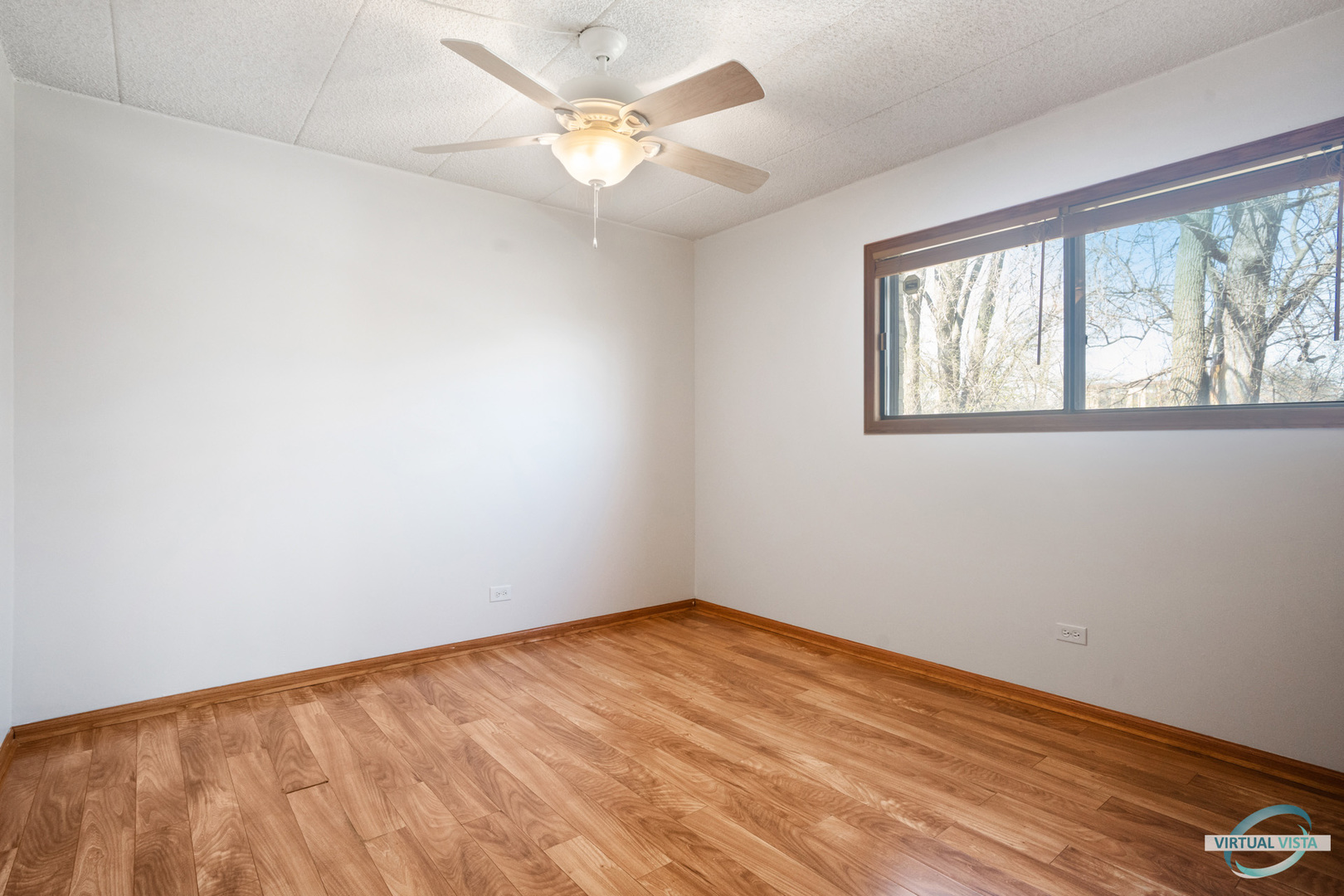 5746 106th Street, Unit 1E Chicago Ridge, IL 60415 - Photo 8 of 21 wooden floor in an empty room with a window
