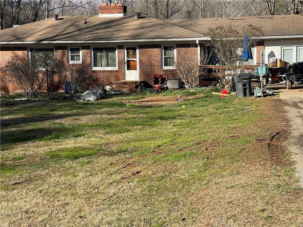 3605 West Ten Road Efland, NC 27243 - Photo 4 of 7 a view of a house with a yard and sitting area