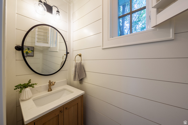 630 East Center Street Alpine, UT 84004 - Photo 76 of 115 Vanity area featuring a wood-finish cabinet with white countertop, integrated sink, and brass-tone faucet