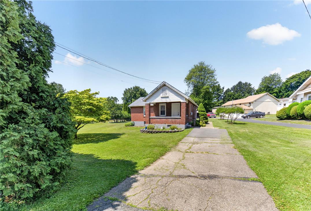 1166 Stones Crossing Road Easton, PA 18045 - Photo 2 of 35 A classic brick facade welcomes you home, nestled amidst mature landscaping and a generous lawn.