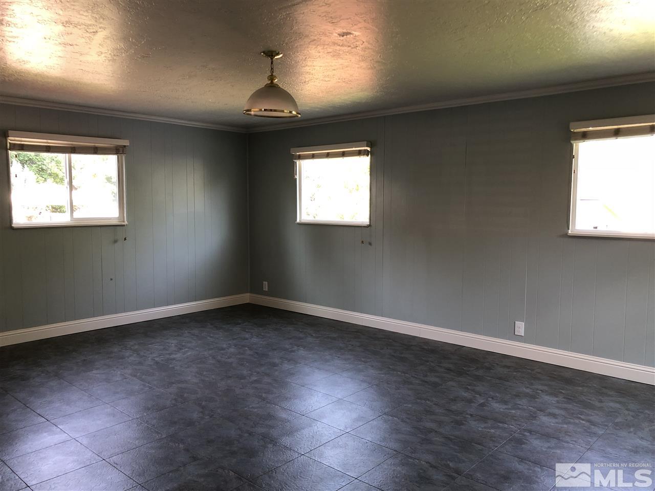 730 Ruby Avenue Reno, NV 89503 - Photo 6 of 13 an empty room with wooden floor and windows