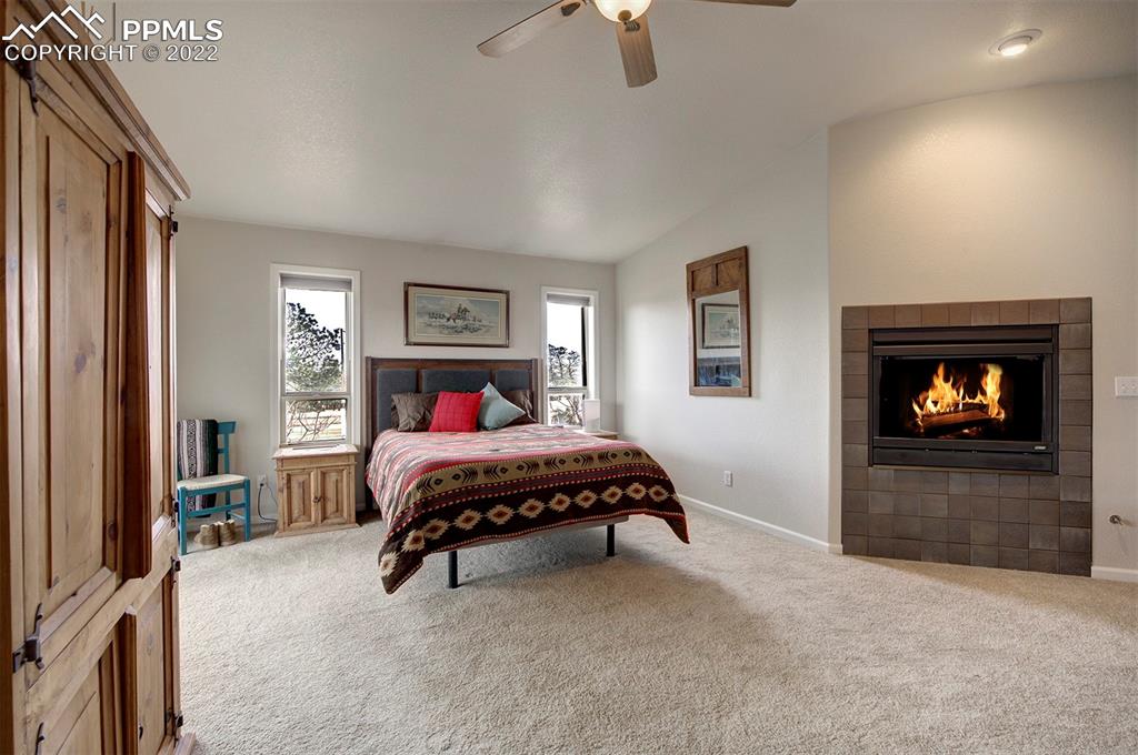 30905 Ridge Road Ramah, CO 80832 - Photo 11 of 36 a bedroom with a bed and a fireplace
