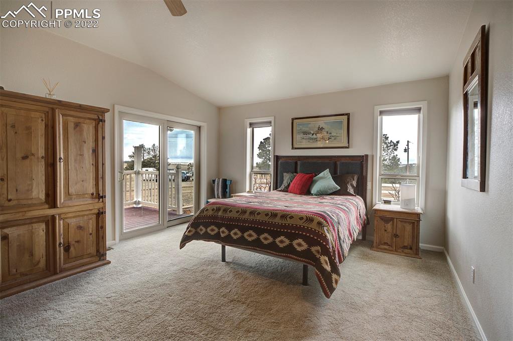 30905 Ridge Road Ramah, CO 80832 - Photo 12 of 36 a spacious bedroom with a bed and glass door